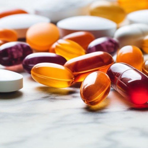vitamin tablets on a white marble counter top